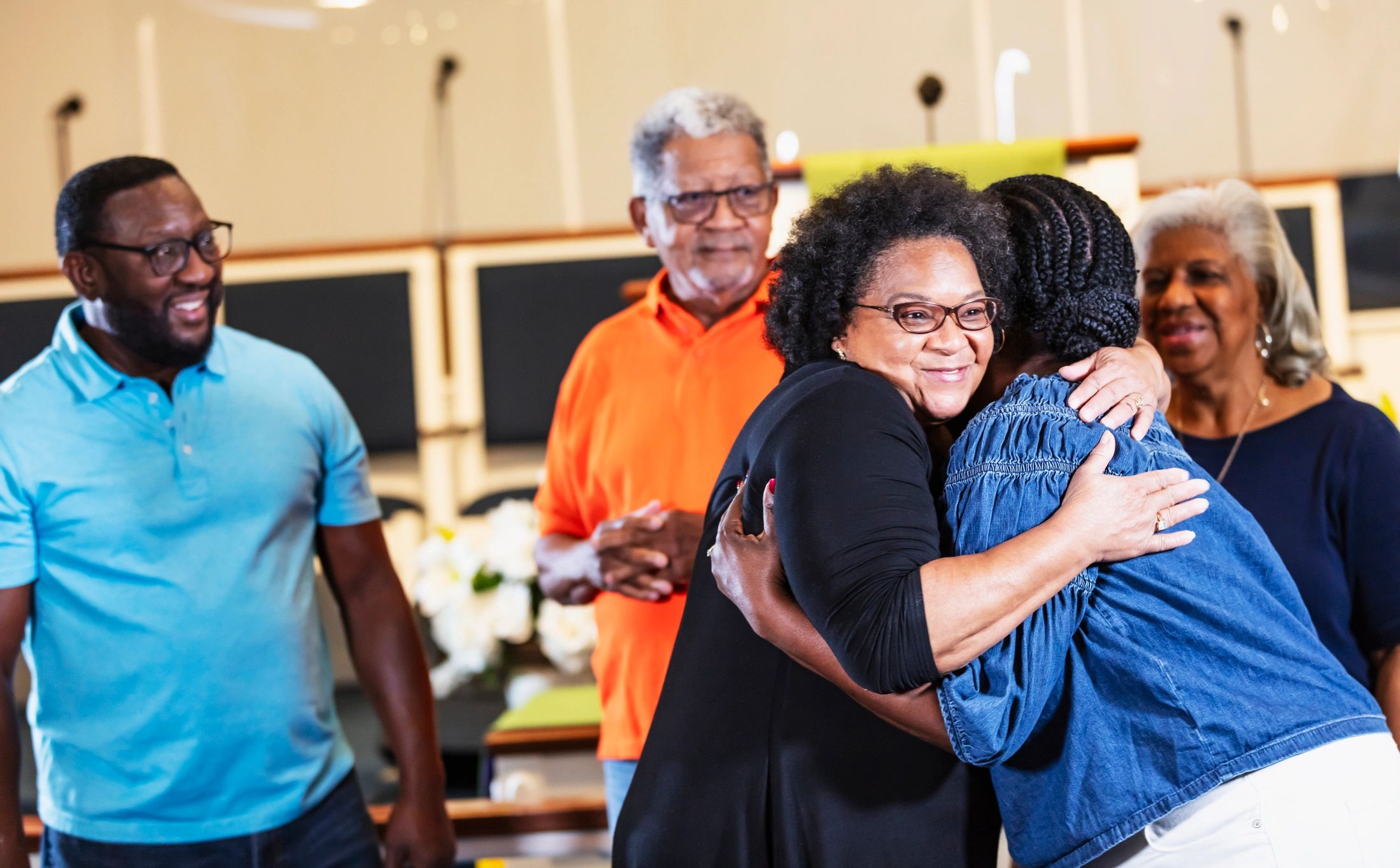 Church members welcoming one another