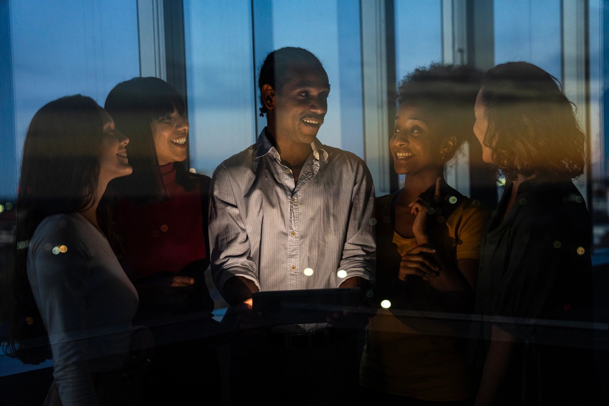 People gathered together in a reflective indoor setting